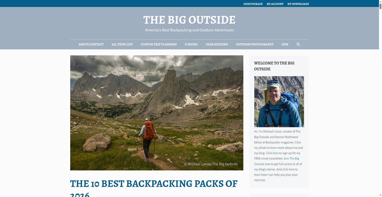 Best backpacking packs review: hiker with orange pack descending rocky alpine trail under storm clouds on The Big Outside