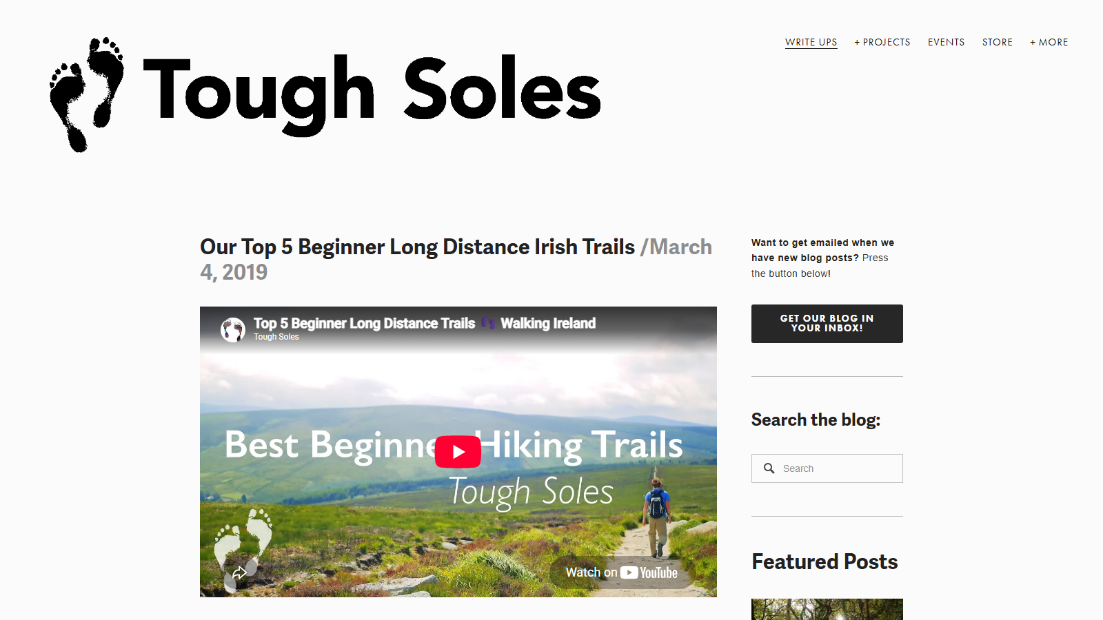 Tough Soles blog post 'Our Top 5 Beginner Long Distance Irish Trails / March 4, 2019' under the site's bare-footprints logo, with an embedded video thumbnail titled 'Best Beginner Hiking Trails' showing a walker on a gravel path across green Irish hills